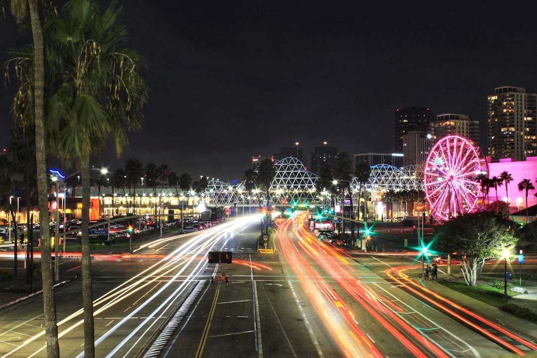 An aerial view of a modern cityscape at night, with interconnected light trails from traffic representing a unified digital network.
