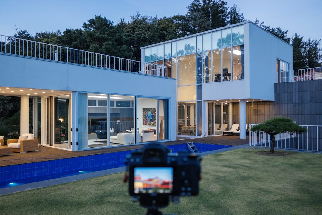 A brightly lit, unique modern architectural model of a house that stands out, representing a real estate brand differentiating itself from a sea of similar online listings.