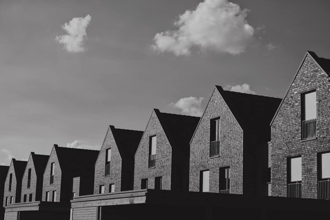 A clean, minimalist photo showing a row of identical modern homes, symbolizing the duplicate content issue in real estate SEO.