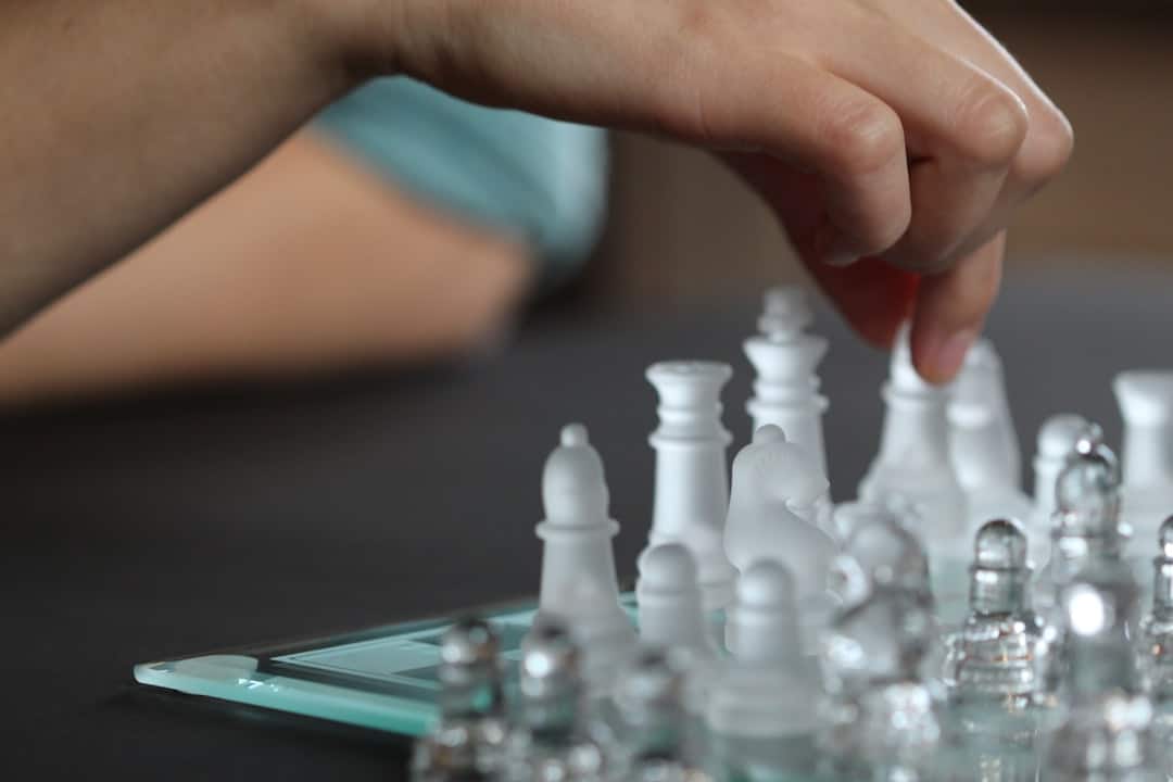 A close-up shot of a minimalist chess game in progress, with one piece making a strategic move, symbolizing market domination.