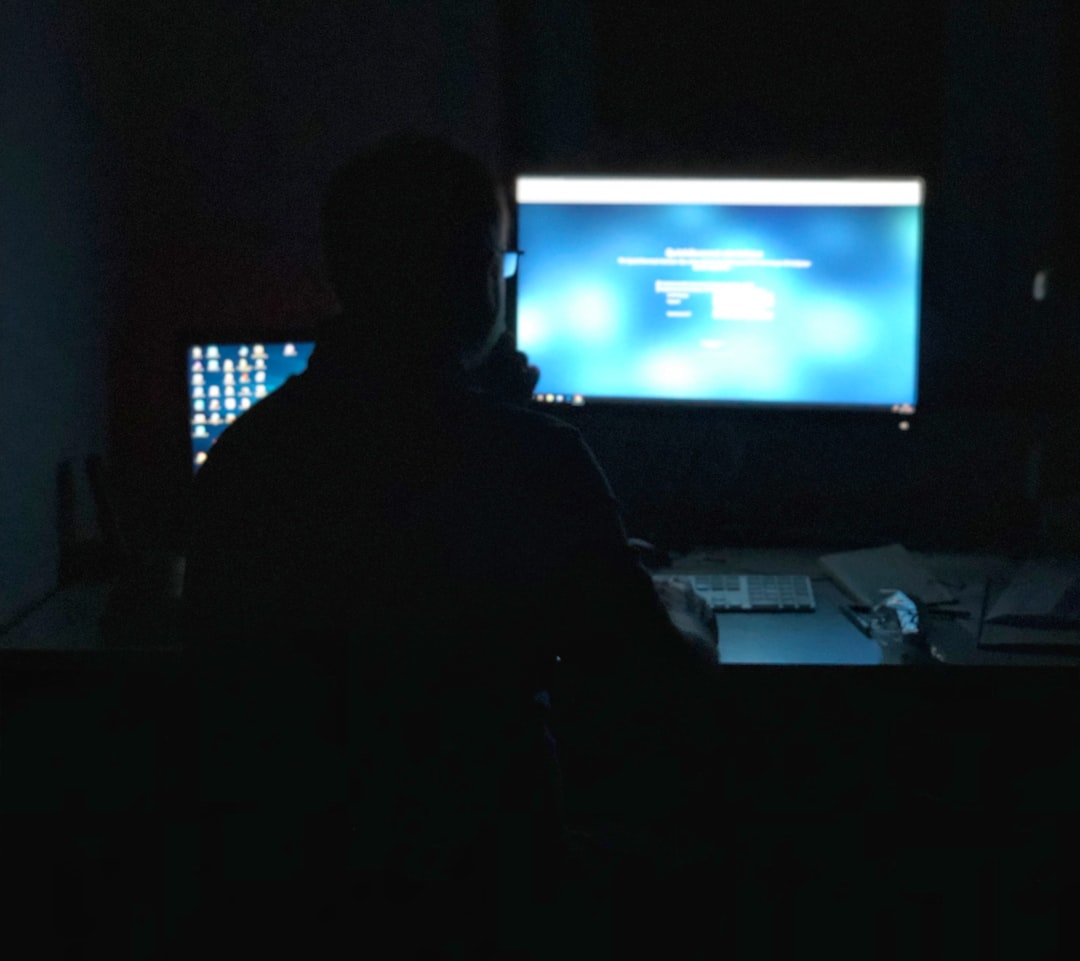 A marketing professional in a modern office looking thoughtfully at a screen displaying glowing data visualizations, representing strategic AI optimization.