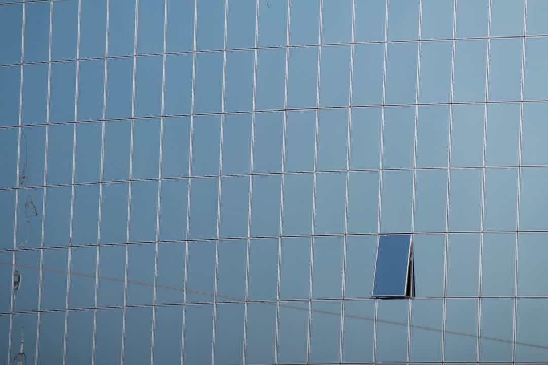 A modern architectural building with a digital wireframe overlay, illustrating the transformation of physical real estate into structured data entities.