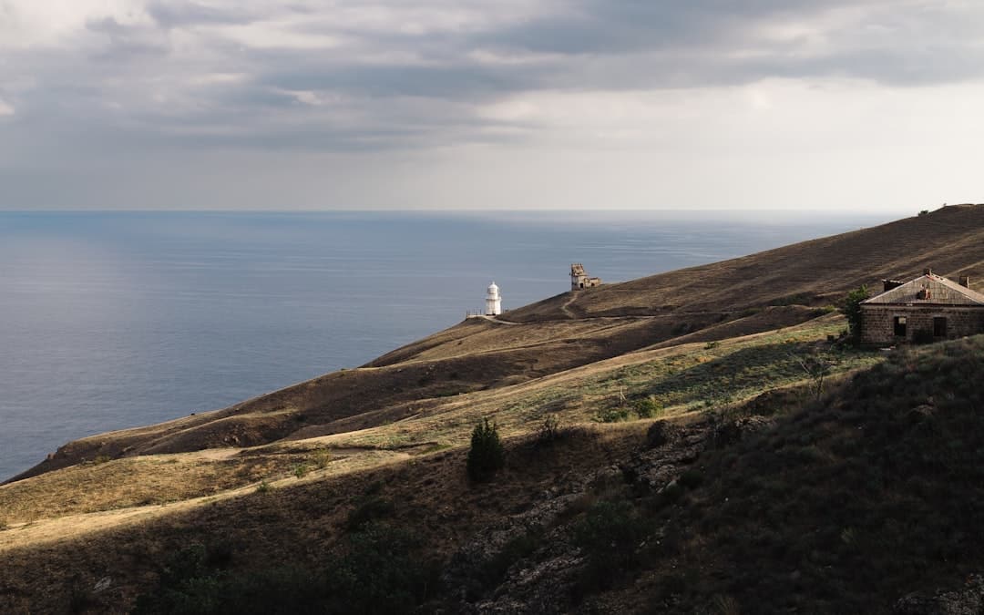 A sleek, modern lighthouse stands as a beacon on a cliff, symbolizing a website becoming the authoritative source of truth that outranks larger portals.