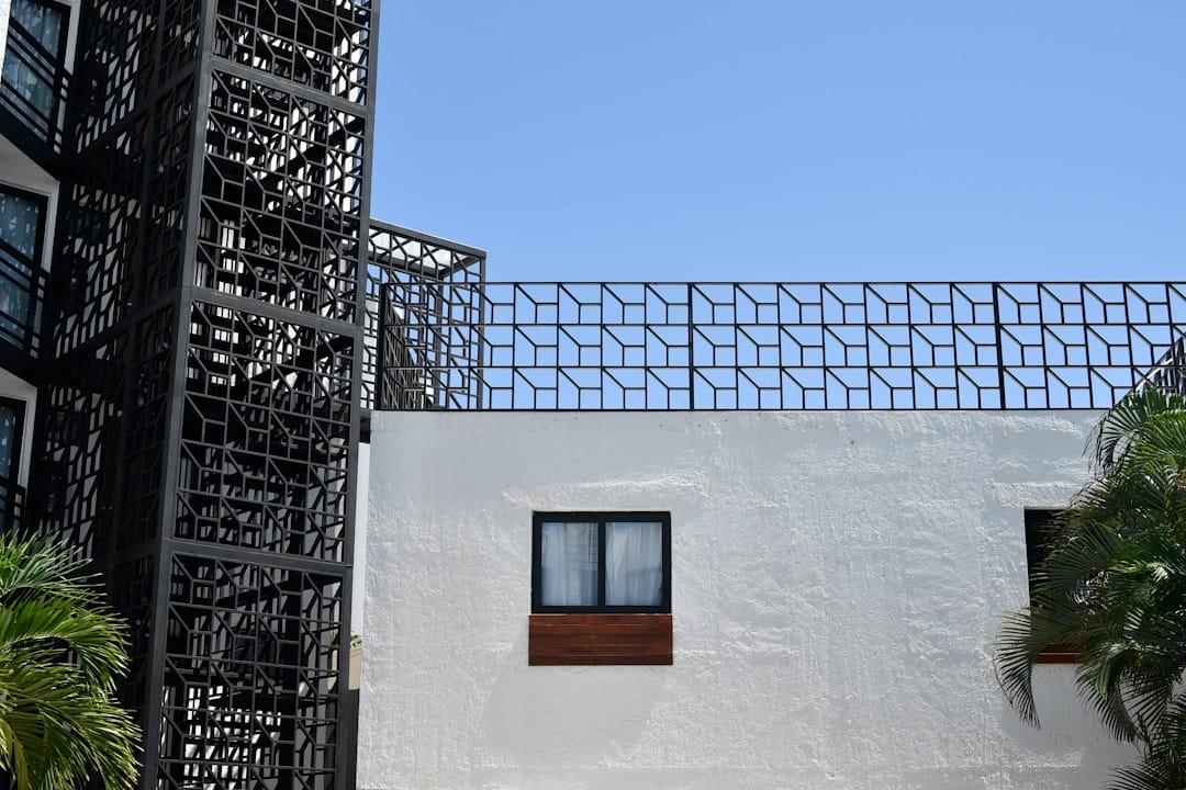 A minimalist photograph looking up at the clean, geometric lines of a modern building against a clear sky, representing a well-architected data structure for SEO authority.