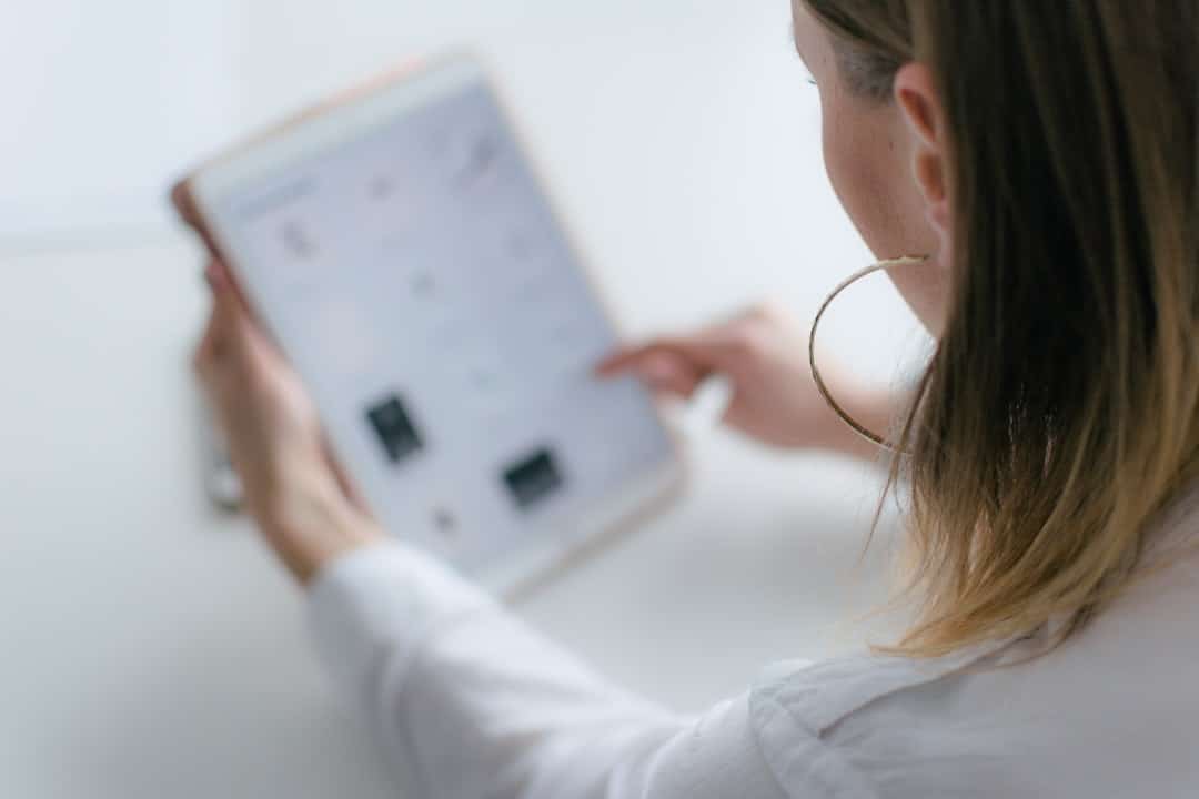 A professional in a modern office looks intently at a complex digital blueprint on a large, bright screen, representing the strategic building of a system.