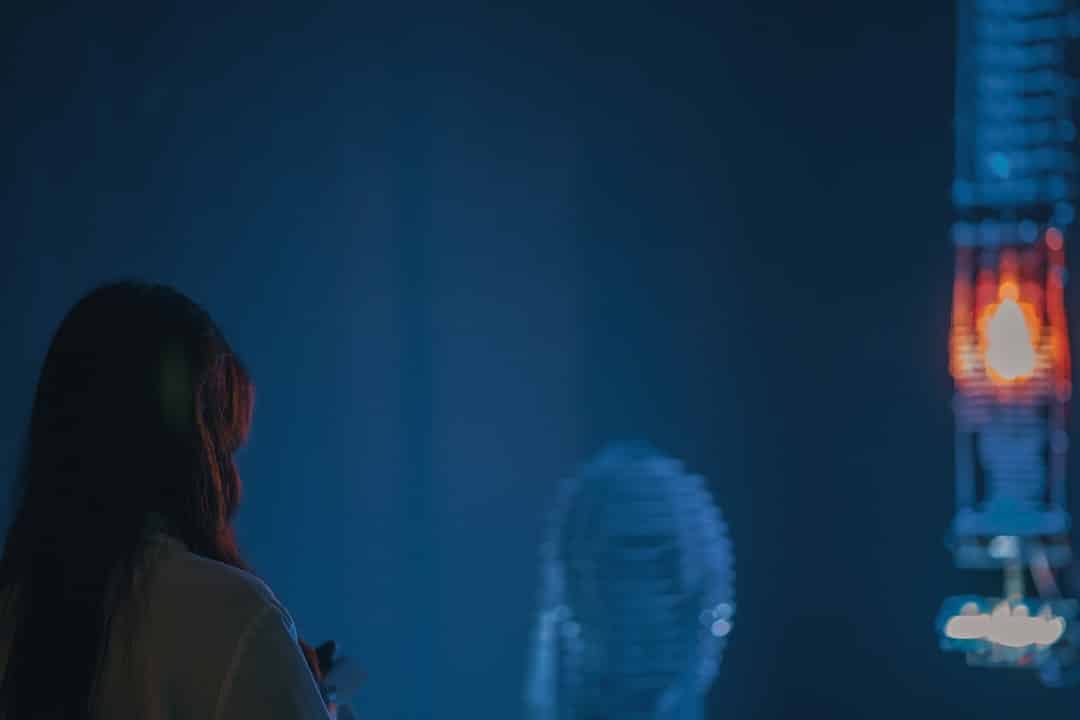 A professional person in a dark, modern office touching a floating, holographic interface displaying glowing data points, representing control and strategy in the age of AI search.