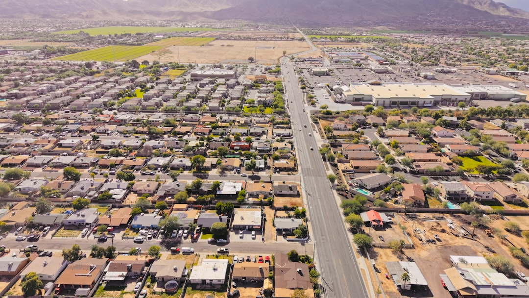 An aerial drone shot of a suburban neighborhood with rows of houses and streets arranged in a clean, orderly grid, symbolizing data standardization.