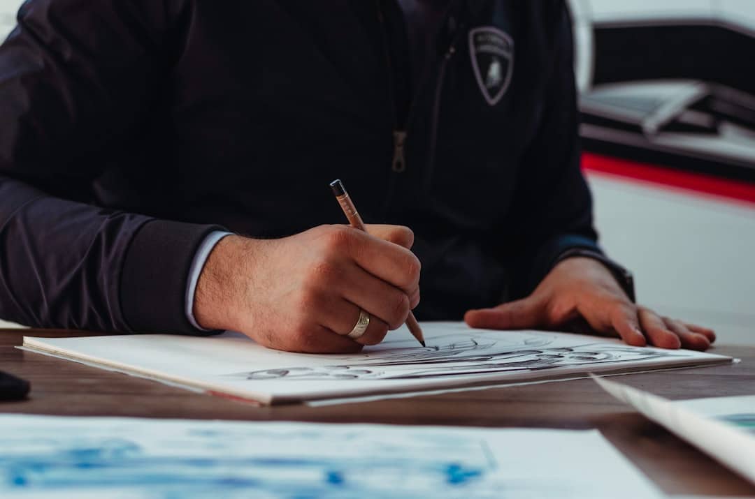 An architect's hands carefully drawing a detailed technical blueprint with precision tools, symbolizing a strategic plan for data unification.