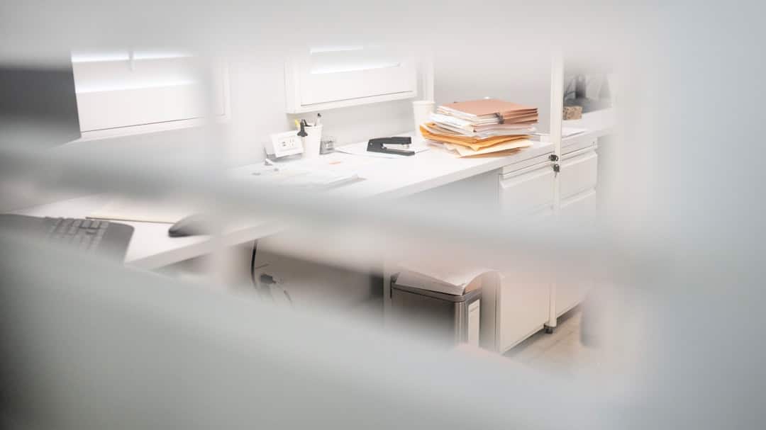 Brightly lit, modern desk with a detailed architectural blueprint spread out, symbolizing a structured and well-designed d...