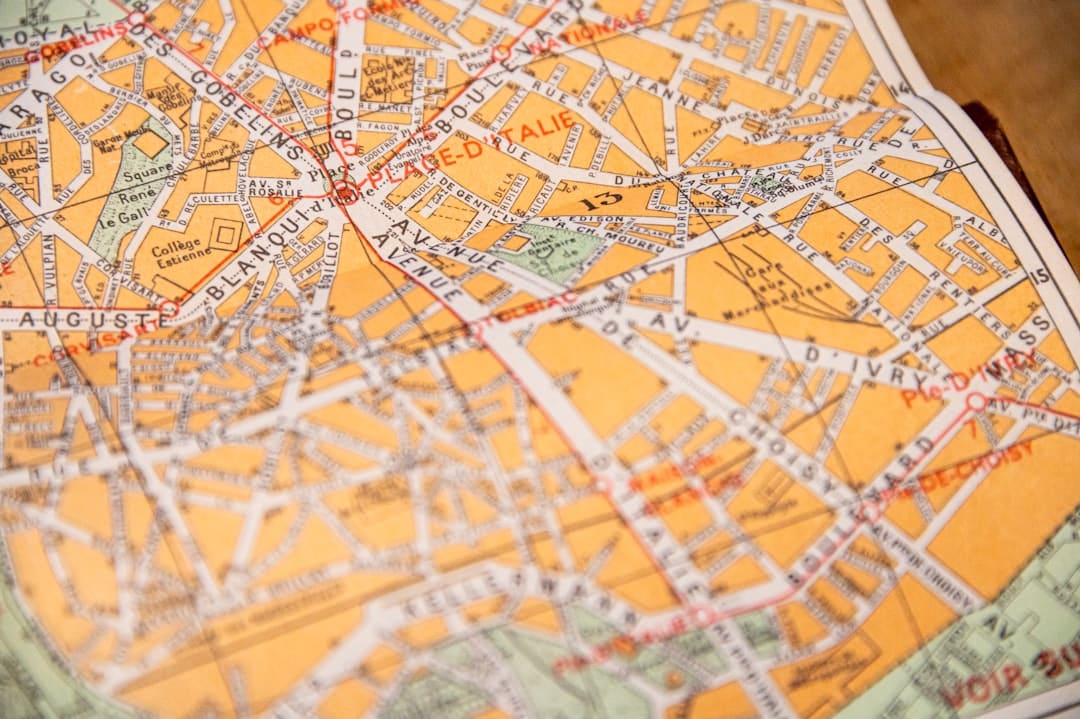 A clean, bright, top-down view of a stylized city map with several colorful location pins placed in distinct neighborhoods, representing a targeted local data strategy.