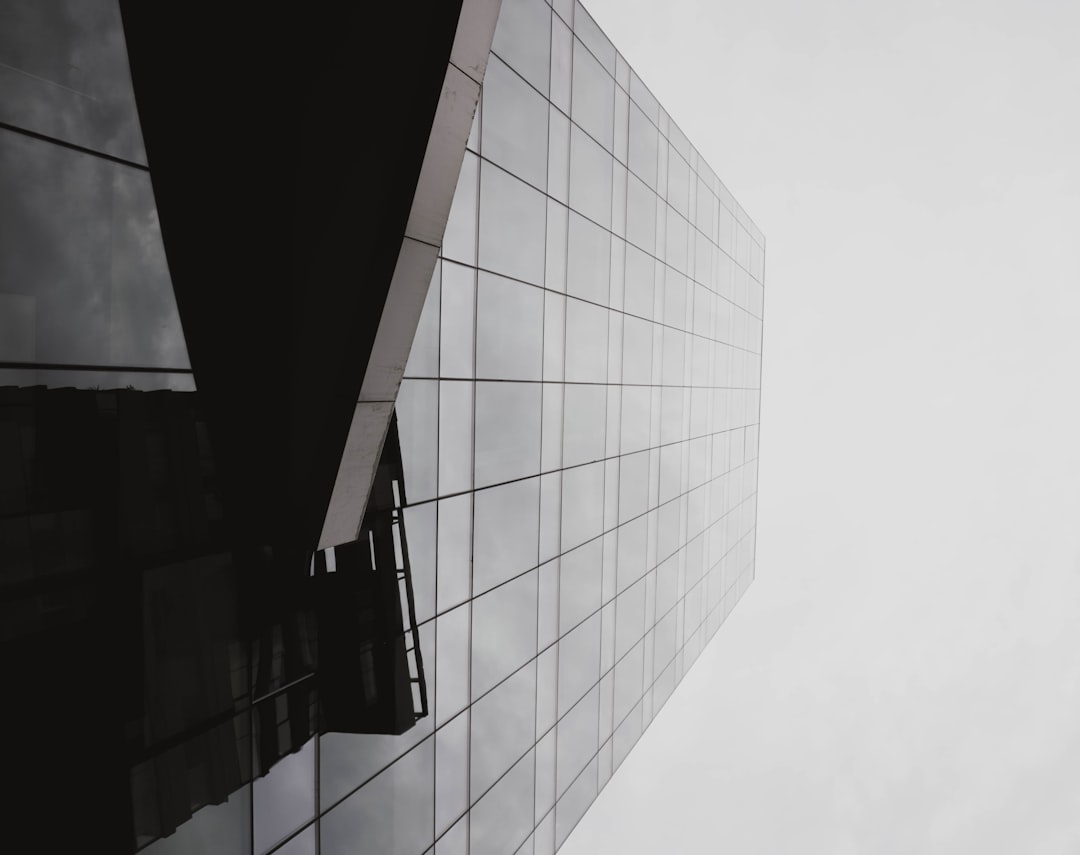 The clean, geometric lines of a modern glass building against a bright sky, representing a well-architected and authoritative business structure.