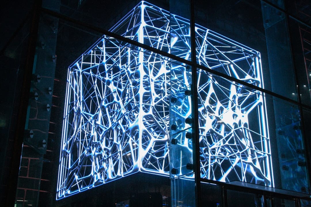 Futuristic glowing blue hologram of a building's architectural blueprint, symbolizing a digital twin replica.