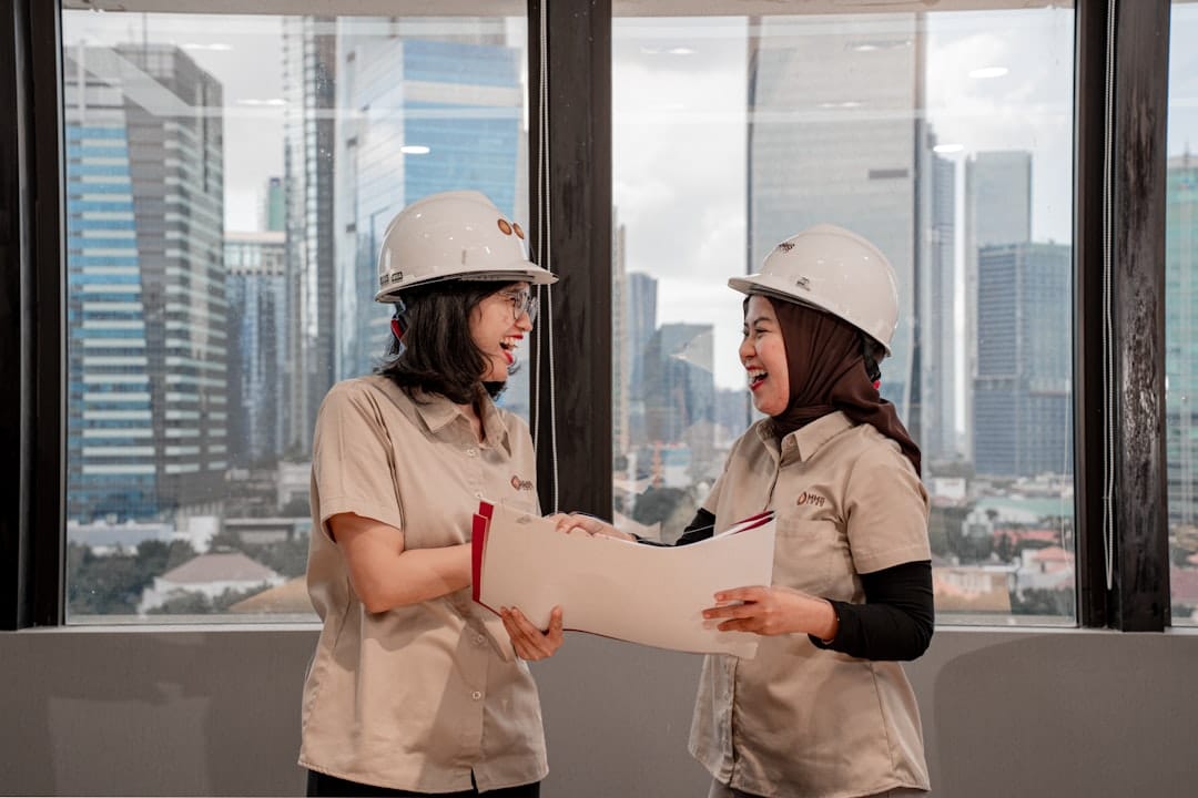 A professional architect carefully reviewing building blueprints on-site, representing the implementation of a maintenance protocol for a digital asset.