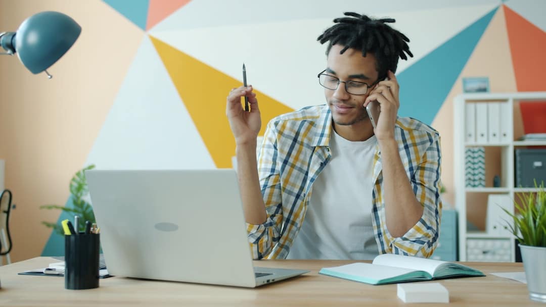 Professional person in a bright, modern office holds a smartphone and speaks into it, using a voice assistant to ask a que...