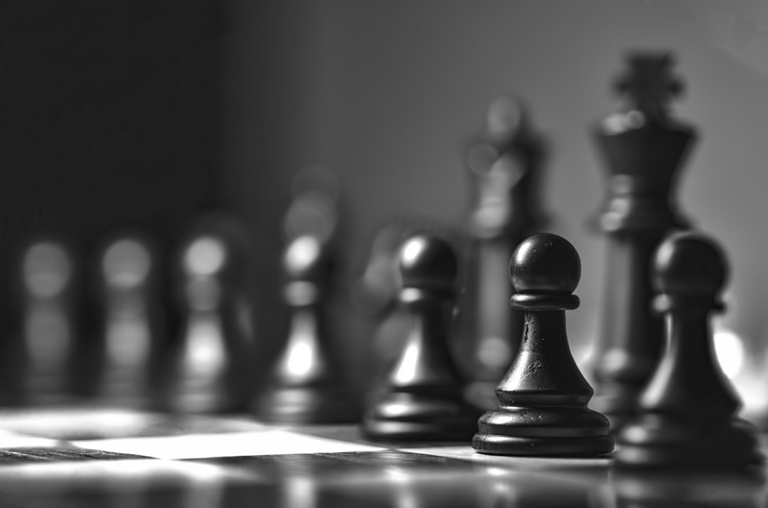 A cinematic close-up of chess pieces on a board, symbolizing the strategic decision-making, risk, and opportunity involved in a high-stakes M&A deal.