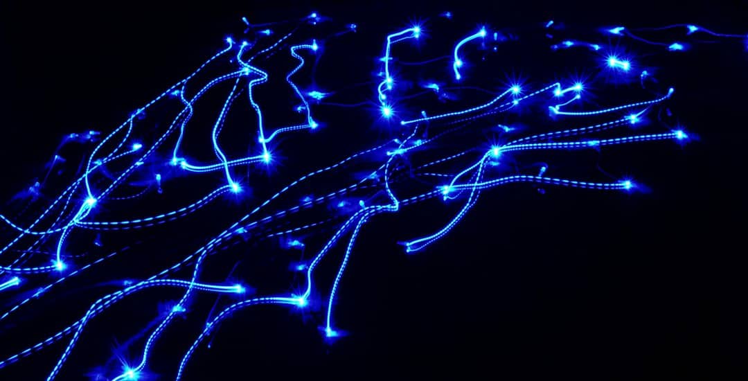 Dark background with an abstract, glowing blue network of interconnected nodes, visualizing the structure of a digital kno...