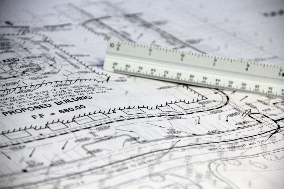 Doctor's stethoscope rests on a detailed architectural blueprint, symbolizing the application of structured data standards...