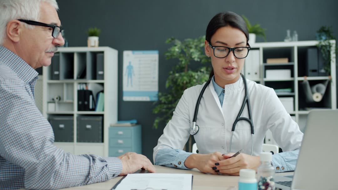 A medical professional in a modern, bright office reviews information on a tablet with a clean, organized interface, representing efficiency in healthcare technology.
