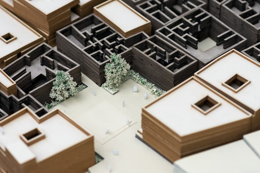 An overhead view of a minimalist architectural model of a city on a clean desk, symbolizing the structured organization of hyper-local real estate expertise.