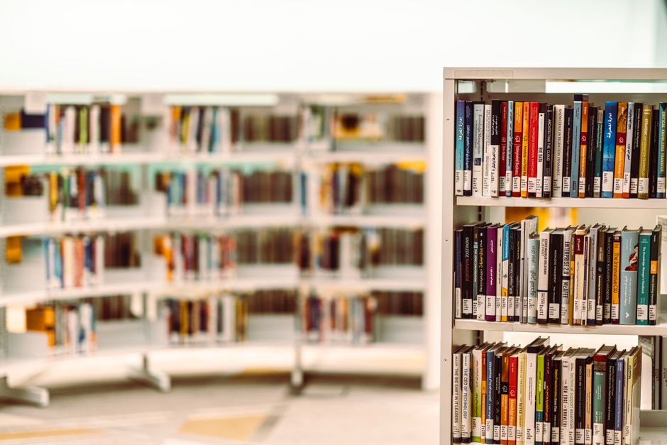 Bright, modern library with perfectly organized, minimalist shelves, representing structured digital brand assets and shel...