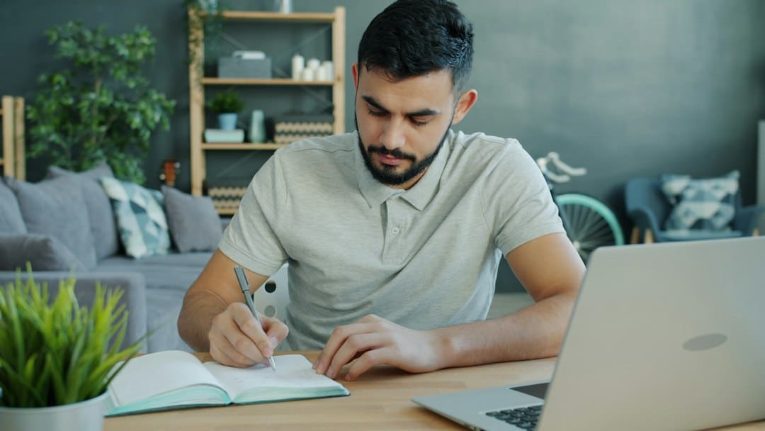 Professional's hands signing a formal document with a fountain pen on a clean, modern desk, symbolizing the act of claimin...